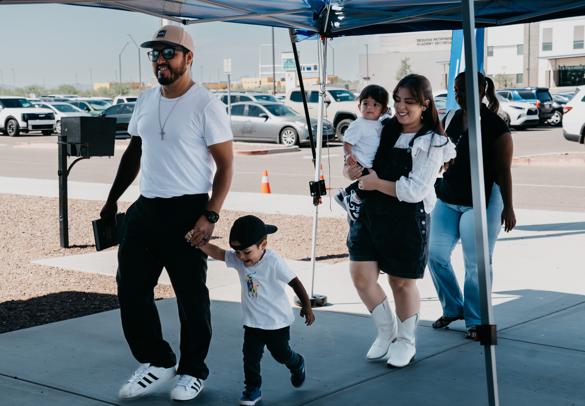 A family arriving at Social Church beneath the welcome canopy.